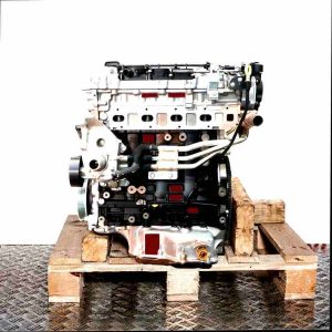 Engine A 22 DM on a wooden pallet against a white background. Side view of the complete engine with attachments.