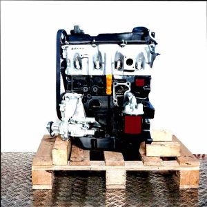 ABS engine on a wooden pallet against a white background. The black and silver engine features a timing belt, spark plugs, and an oil dipstick.