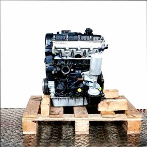 AJM engine on a wooden pallet against a white background. The black and silver engine with yellow accents is shown from the side.