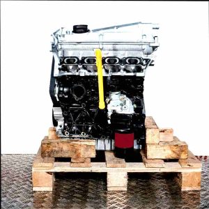 AJQ engine on a wooden pallet against a white background. Side view of the complete engine featuring a silver cylinder head and black engine block.