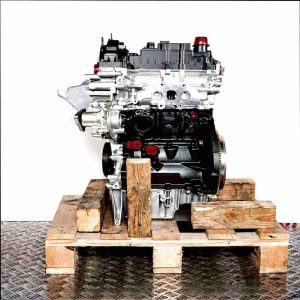 B7DA engine on a wooden pallet against a white background. The silver and black engine with yellow accents is viewed from the side.