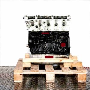 BBF engine block on a wooden pallet against a white background. Side view of the silver and black engine.