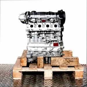 BLY engine on a wooden pallet against a white background. Side view of the engine in a vertical orientation.