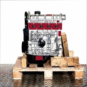 Side view of the BXW engine on a wooden pallet against a white background. The silver and black engine displays detailed surface features.