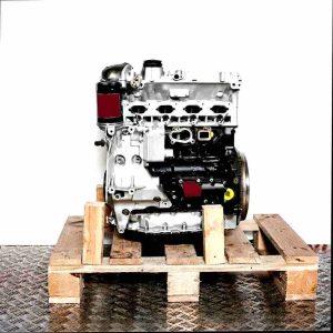 BZB engine on a wooden pallet against a white background. Side view of the engine in a vertical orientation.