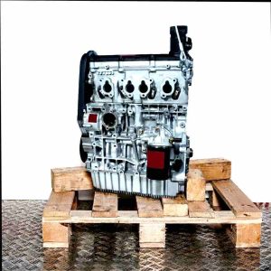 CCSA engine on a wooden pallet against a white background. The silver engine with black components is vertically oriented.