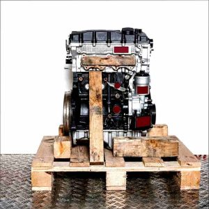 CFFB engine on a wooden pallet against a white background. Black and silver engine, side view.