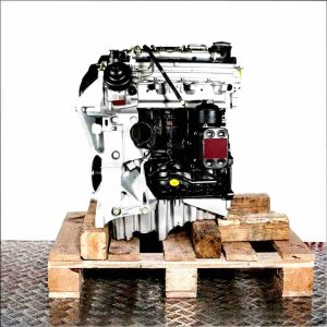 Side view of the CGLE engine on a wooden pallet against a white background. The silver and black engine with yellow accents is positioned vertically.