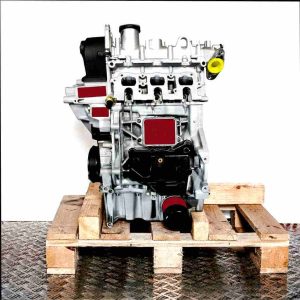 Side view of the CHZB engine on a wooden pallet against a white background. The silver engine with black attachments is vertically oriented.