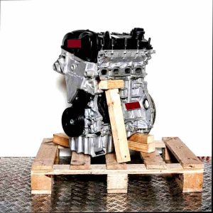 CHZD engine on a wooden pallet against a white background. The silver engine with black and yellow accents is shown from the side.