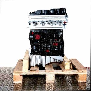 CJCD engine on a wooden pallet against a white background. The engine block is black, with a silver cylinder head and oil pan.