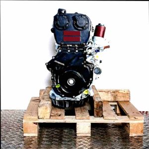 CJSB engine in black and grey, displayed on a wooden pallet against a white background. Side view of the engine, oriented vertically.
