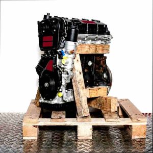 Side view of a black and silver CJXC engine on a wooden pallet against a white background. Yellow accents are present.