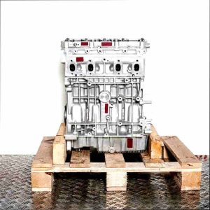 Side view of CMXA engine on a wooden pallet against a white background. Intake manifold and engine block are clearly visible.