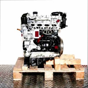 CYMC engine on a wooden pallet against a white background. The silver and black engine is shown from the side.