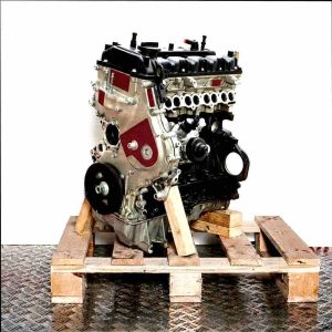 D4FC engine on a wooden pallet against a white background. Side view, slightly angled from the front.