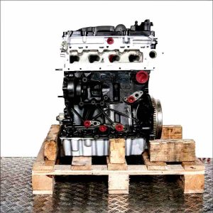 DDYA engine on a wooden pallet against a white background. The black engine block with silver cylinder head and oil pan features yellow covers.
