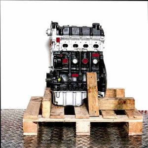 DDYB engine on a wooden pallet, side view. Silver top and black bottom of the engine against a white background.