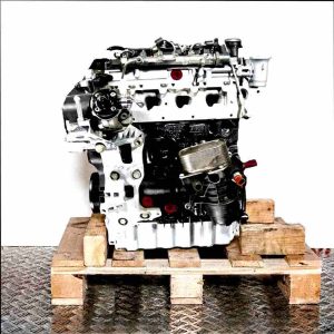 Side view of the DFLD engine on a wooden pallet against a white background. The black and silver engine, with yellow and green accents, displays various components.