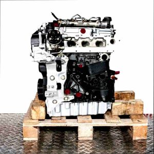 Side view of the DFSE engine on a wooden pallet against a white background. The gray and black engine, featuring yellow accents and green connectors, is oriented vertically.