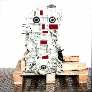 Side view of a DKRC engine on a wooden pallet against a white background. The silver engine is fully visible.