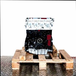 F9Q 710 engine on a wooden pallet against a white background. The black engine block and silver cylinder head are visible.