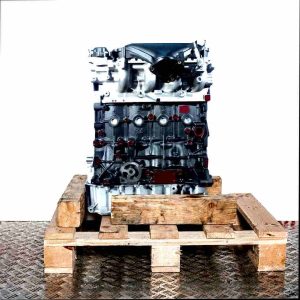 G6DA engine on a wooden pallet against a white background. The engine block is black, with silver components. Side view.