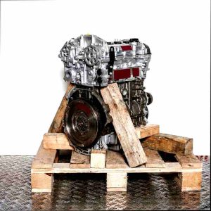 SFJE engine on a wooden pallet against a white background. Side view showcasing gears and a circular disc.