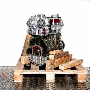 SFJK engine block on a wooden pallet against a white background. This image displays a silver engine, split to reveal internal components.