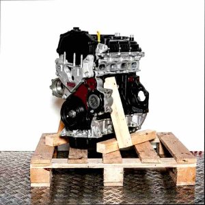 YMCB engine on a wooden pallet against a white background. The silver and black engine is viewed from the side, slightly angled from below.