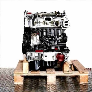 YMHA engine on a wooden pallet against a white background. Side view of the black and silver engine, vertically oriented.