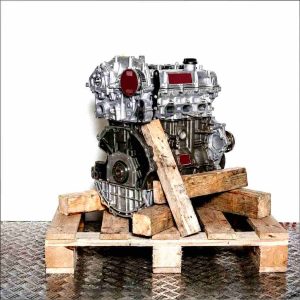 YYJE engine on a wooden pallet against a white background. Side view of a partially disassembled engine, showing gears and crankshaft housing. No watermarks.