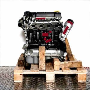 Z 14 XEP engine in black and grey on a wooden pallet against a white background. The engine, with small parts in a plastic bag, is viewed from the side.